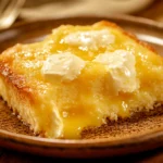 Golden Lemon Dump Cake with pockets of cream cheese and glossy lemon curd
